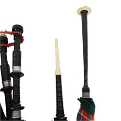 Set of ebonised wooden bagpipes, with new bag in Cameron of Lochiel tartan, contained in leather suitcase with initials PAJ to cover