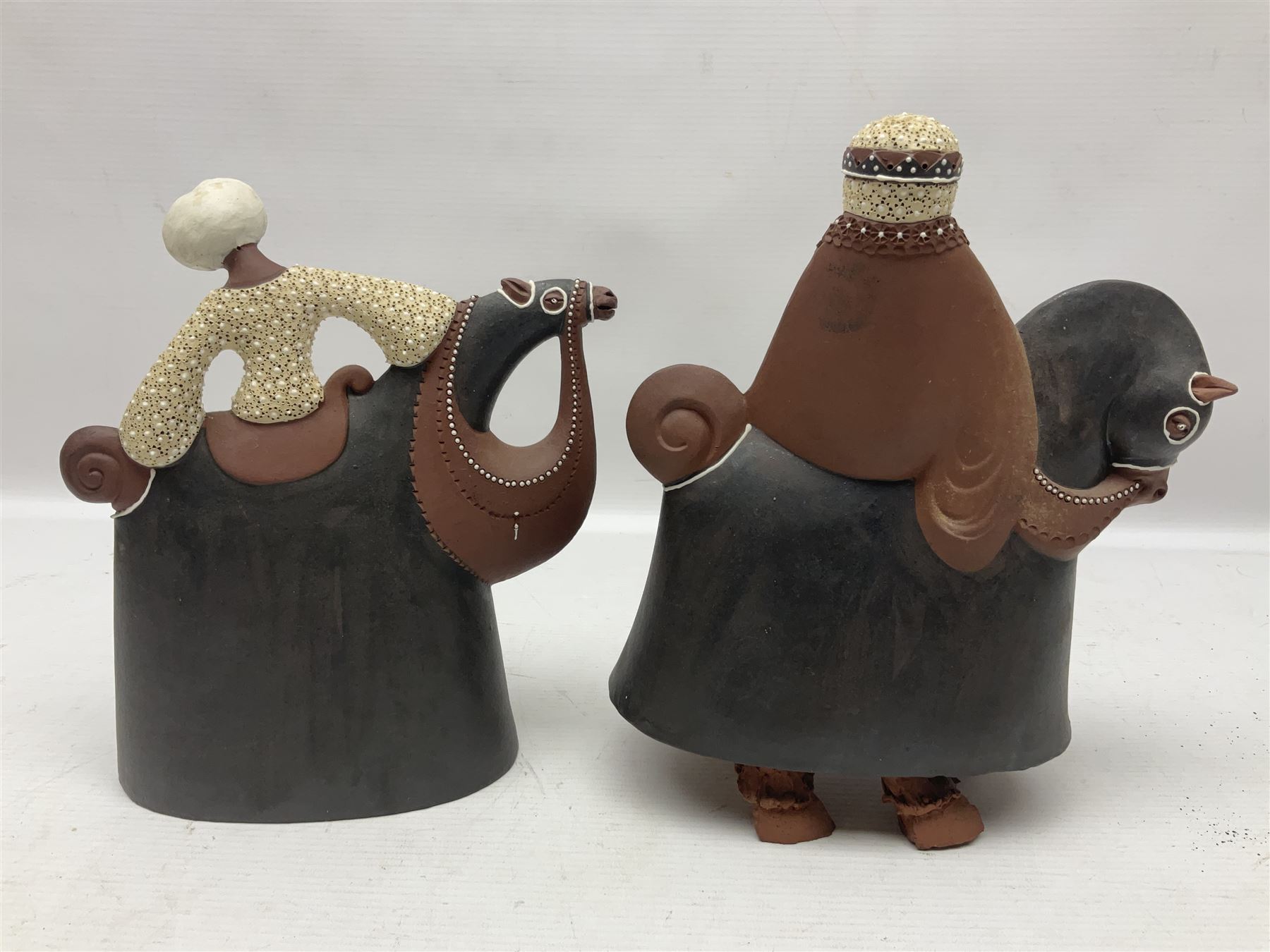 Leonard Stockley; two studio pottery figures modelled as a king and queen upon horses, both signed beneath,  H25cm