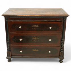 19th century painted pine chest of drawers, the rectangular top with moulded edge and painted floral decoration, above three drawers with later ceramic handles, with half turned column and reeded pilasters, upon turned compressed bun feet  
