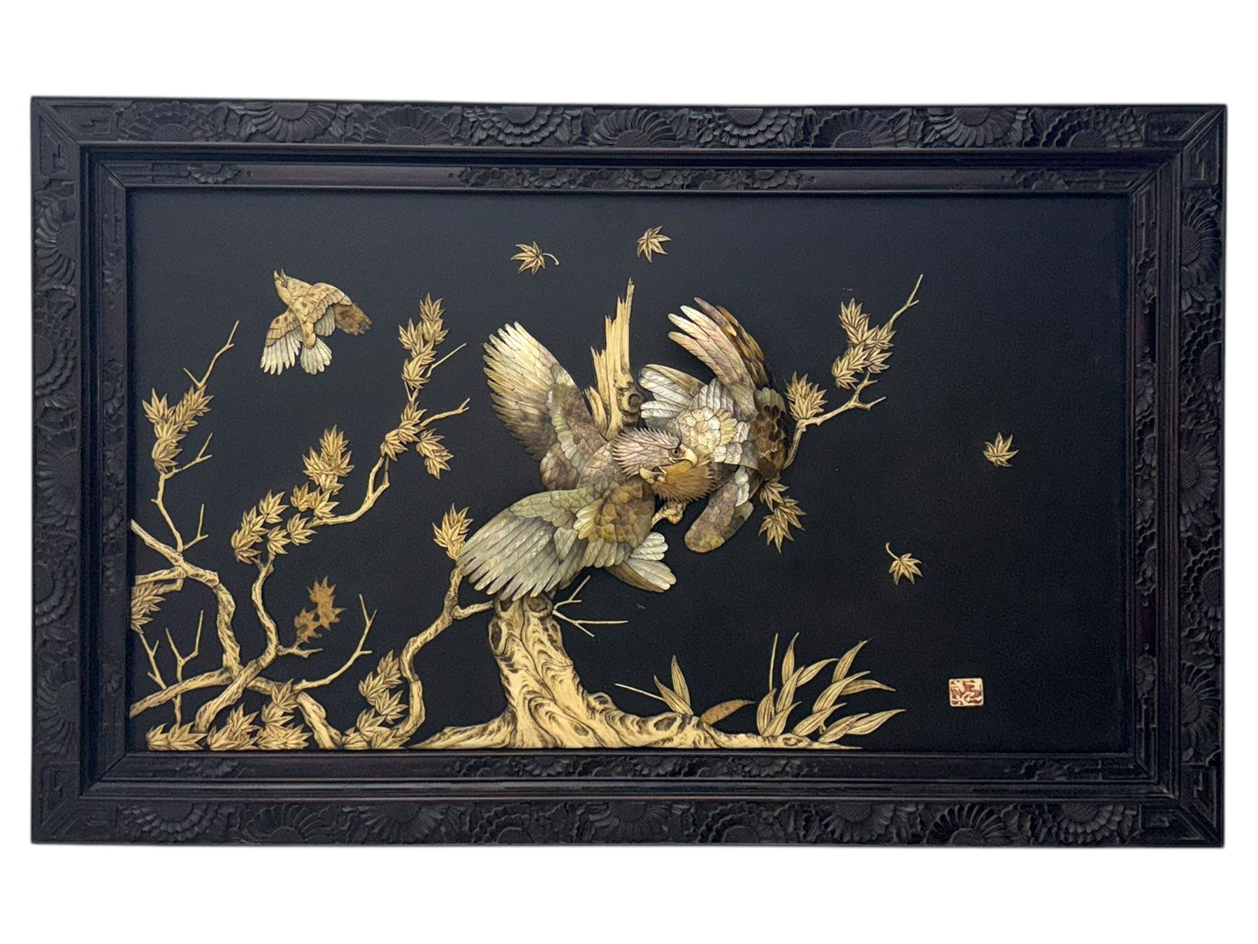 Meiji period (1868–1912), signed Shibayama carved hardwood lacquer panel inlaid with mother-of-pearl and ivory, decorated in high relief and inlaid, depicting two birds of prey with locked talons and beaks on leafy tree branch, signature in lower right corner, in original frame. This item has been registered for sale under section 10 of the APHA Ivory Act