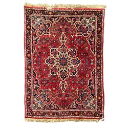 Persian Hamadan crimson ground rug, central floral pole medallion with matching spandrels, the guarded indigo border with interlaced palmettes