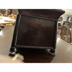 Early 19th century rosewood and brass inlaid tea caddy, of sarcophagus form, the front and hinged opening cover inlaid with brass scrolling panels, opening to reveal a compartmented interior with twin removable boxes with conforming inlaid brass detail to the hinged covers and zinc lining to the interiors, flanking a later glass mixing bowl, the whole upon four turned cylindrical feet, H21cm W36cm D20cm