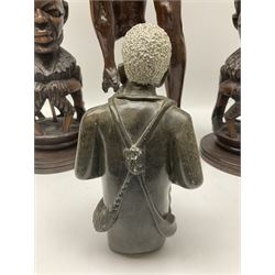 Pair of 20th century carved wood table lamp with African busts and figures, together with a carved wooden figure and soapstone figure, lamps H44cm