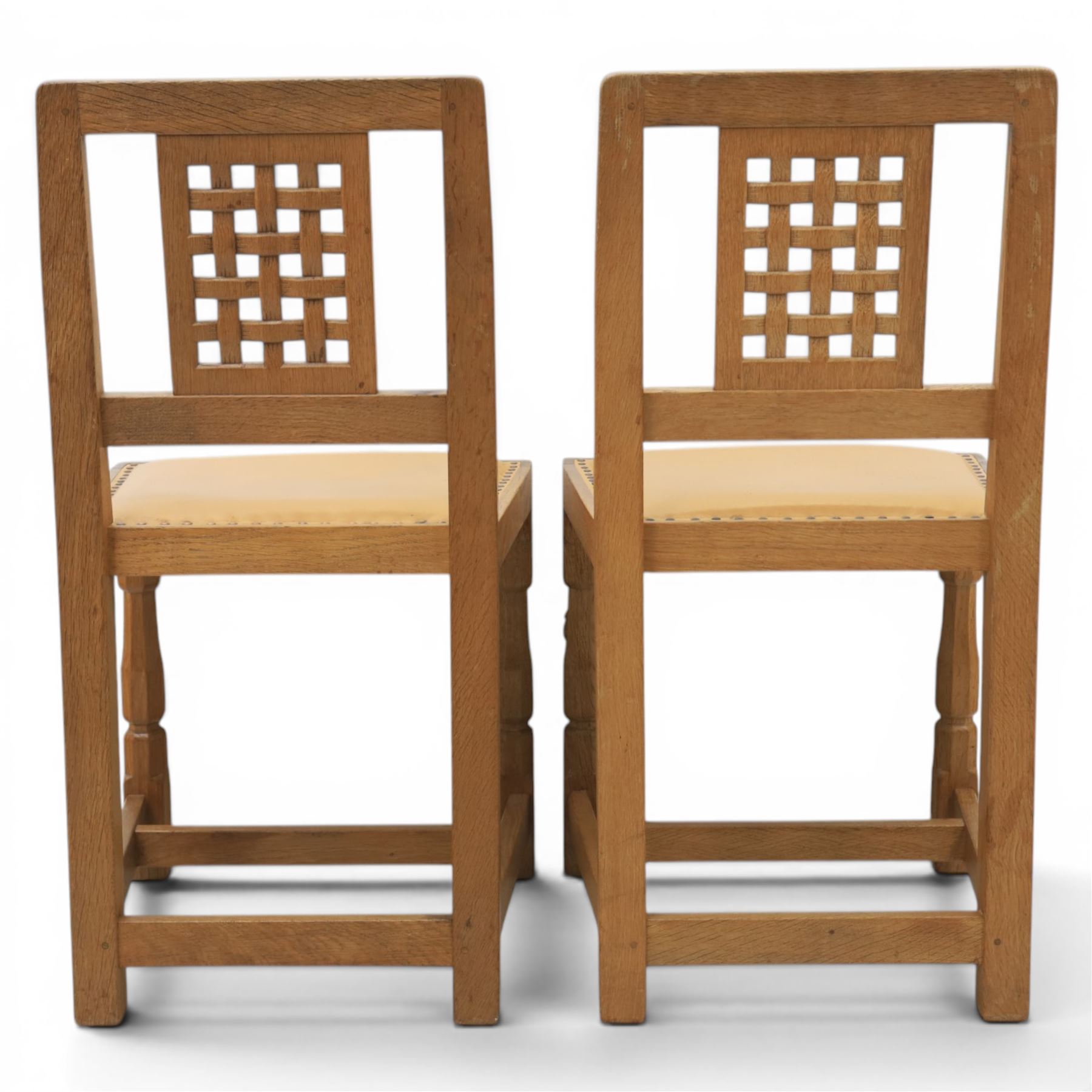 Mouseman - set of four oak lattice back chairs with tan seat with brass studded trim, with carved mouse signature, by the workshop of Robert Thompson of Kilburn