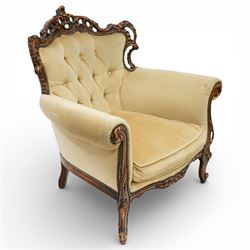 Late 19th century style carved hardwood armchair, the openwork crest rail with scrolling and foliate ornament, upholstered back and outscrolled arms with buttoning, loose seat cushion, nailhead trim, on carved cabriole legs
