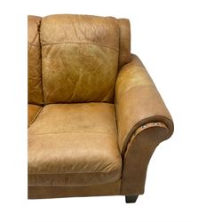 20th century traditional three seat sofa with rolled arms, upholstered in tan leather, on tapering feet
