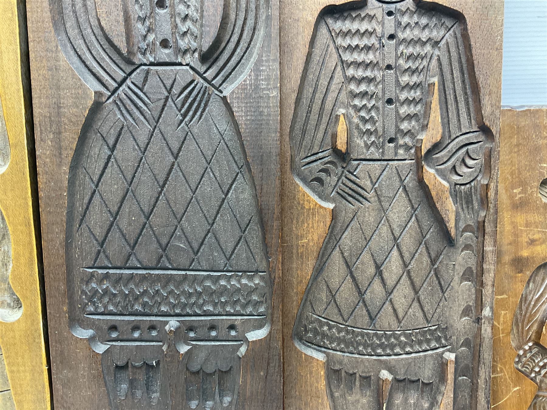 Six 20th century hardwood Dutch folk art Speculaasplank or biscuit moulds, typically carved with figures in traditional dress, largest H101cm