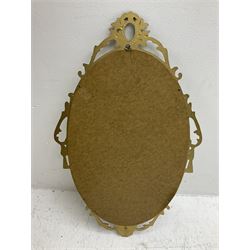 Ornate brass wall mirror with oval plate, L78cm