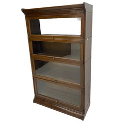 Early 20th century oak stacking library bookcase, four sections enclosed by hinged and sliding glazed doors