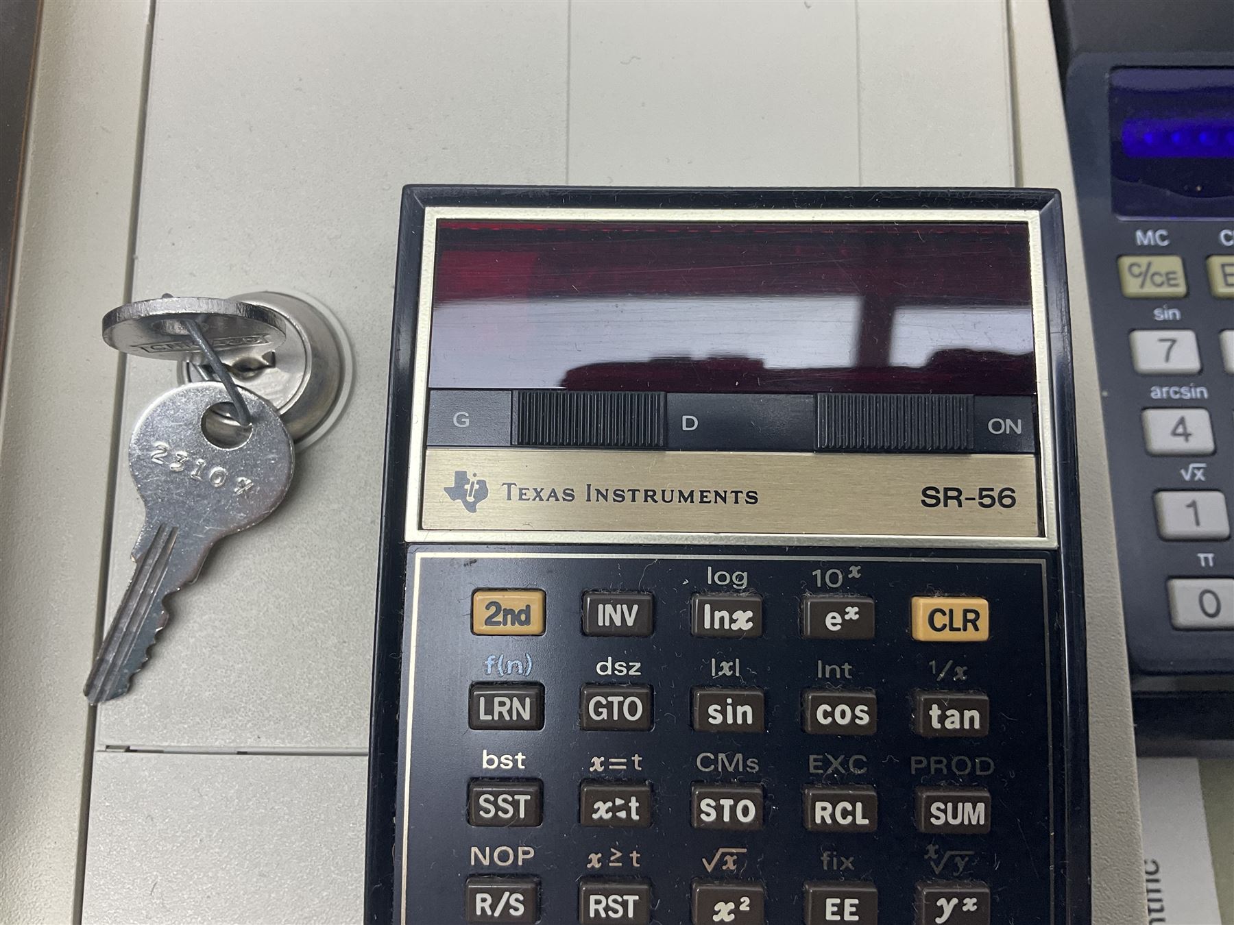 Four 1970s Sinclair electronic calculators - Cambridge in hard case with booklet; Scientific Programmable with Program Library and booklet; Scientific in hard case; and Oxford 300 in soft case with booklet; together with Texas PC-100 SR56 programmable slide-rule calculator on base station with readout, two booklets, keys and cover, serial no.9103093