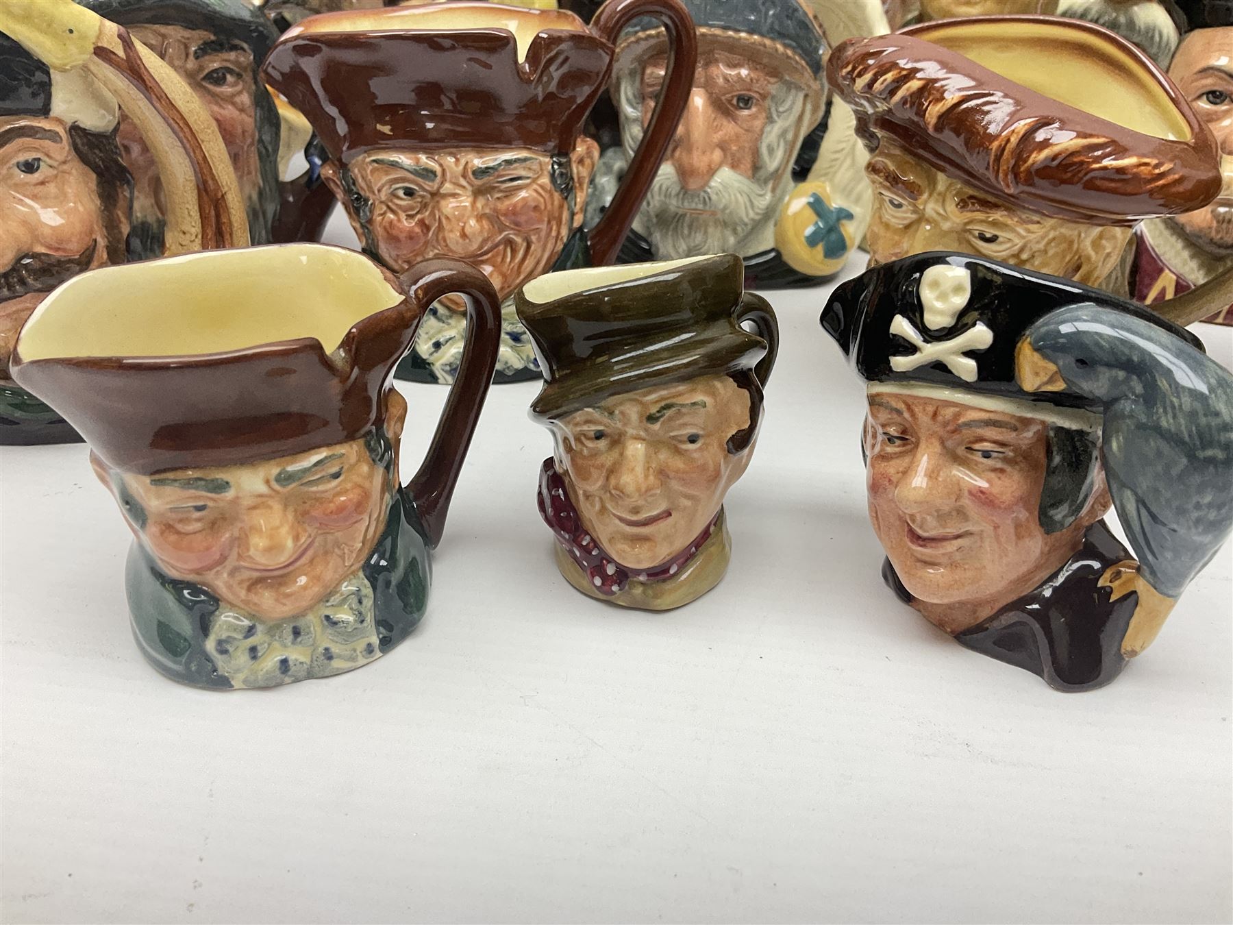 Large collection of Royal Doulton character jugs, to include Robinson Crusoe D6532, Tam O Shanter D6632, The Falconer D6533 etc, together with similar charater jugs and toby jugs   