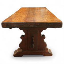 Early 20th century French oak refectory table, the thick rectangular top with cleated ends above shaped lyre-form trestle supports, united by a central stretcher, on broad scrolled feet, displaying well-figured quarter sawn grain across the top