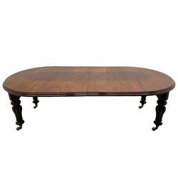 Victorian mahogany extending dining table, circular telescopic extending top with moulded edge, two additional leaves, on turned and lobe carved supports with brass and ceramic castors 