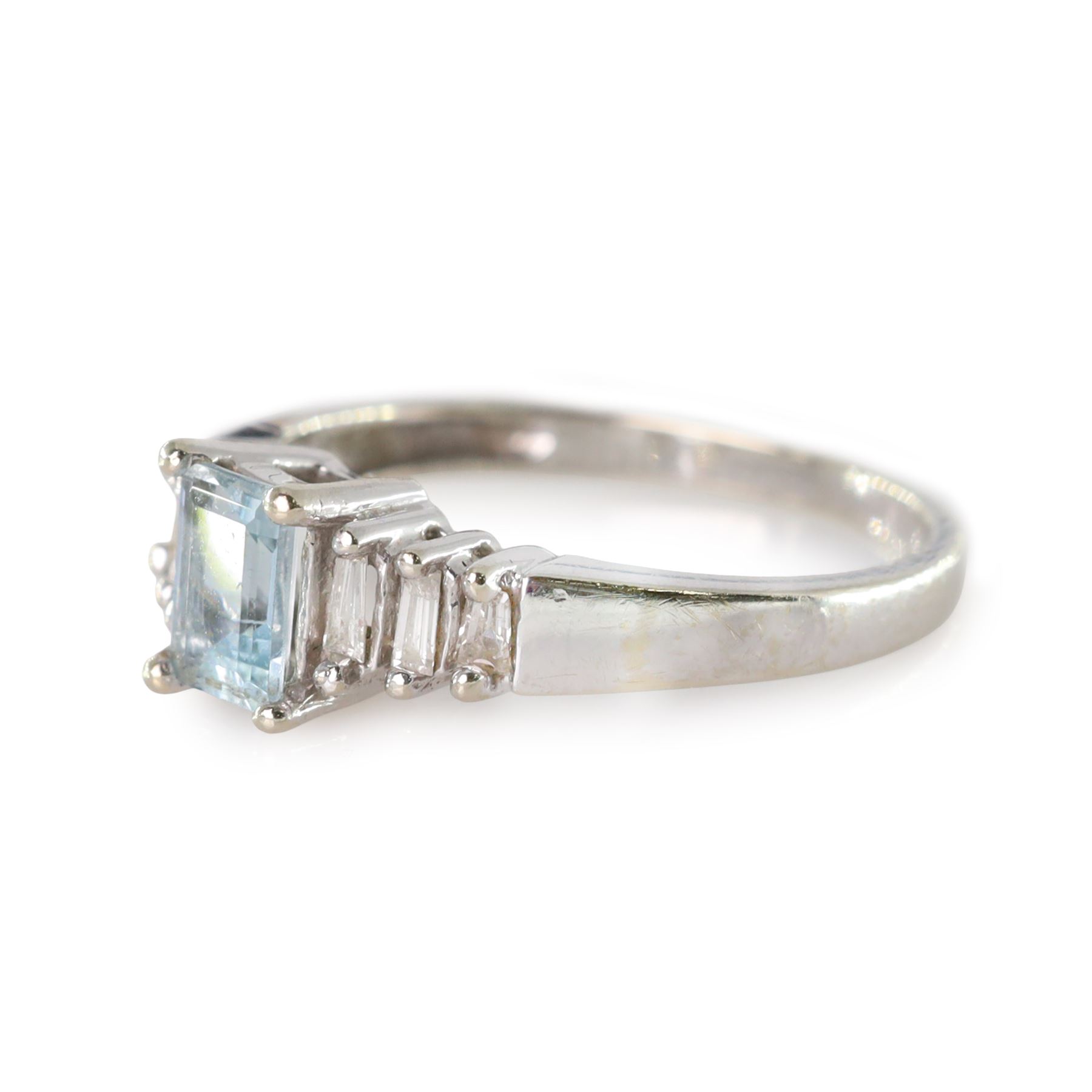 10ct white gold aquamarine and diamond ring, single octagonal cut aquamarine of approx 0.45 carat, with three tapered baguette cut diamonds set either side, stamped