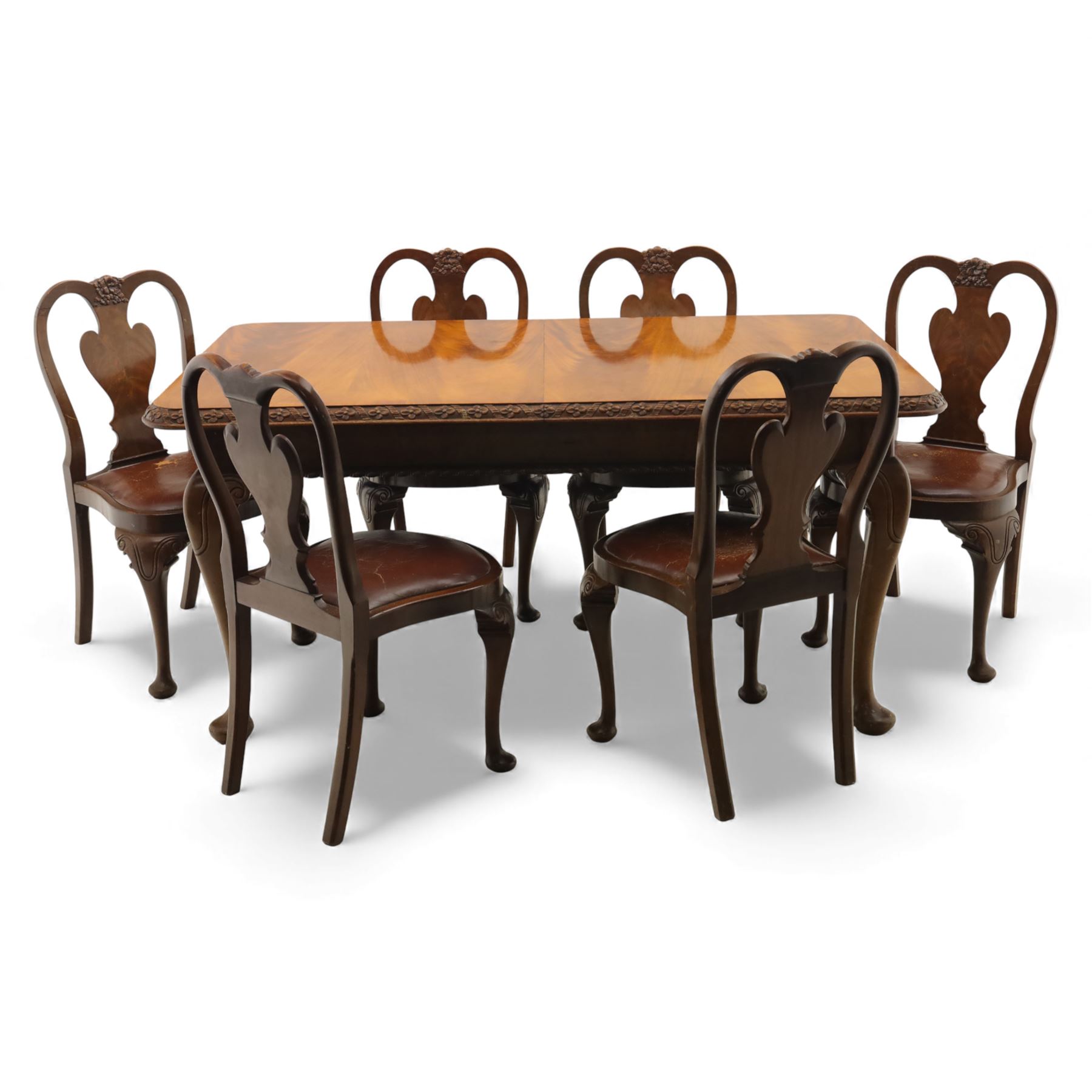 Queen Anne design walnut dining suite, comprising a rectangular dining table with carved moulded edge and rounded corners, raised on cabriole legs terminating in pad feet, together with a set of six matching dining chairs, each with shaped splat back, leather upholstered seat and cabriole supports (Extends to 230cm)