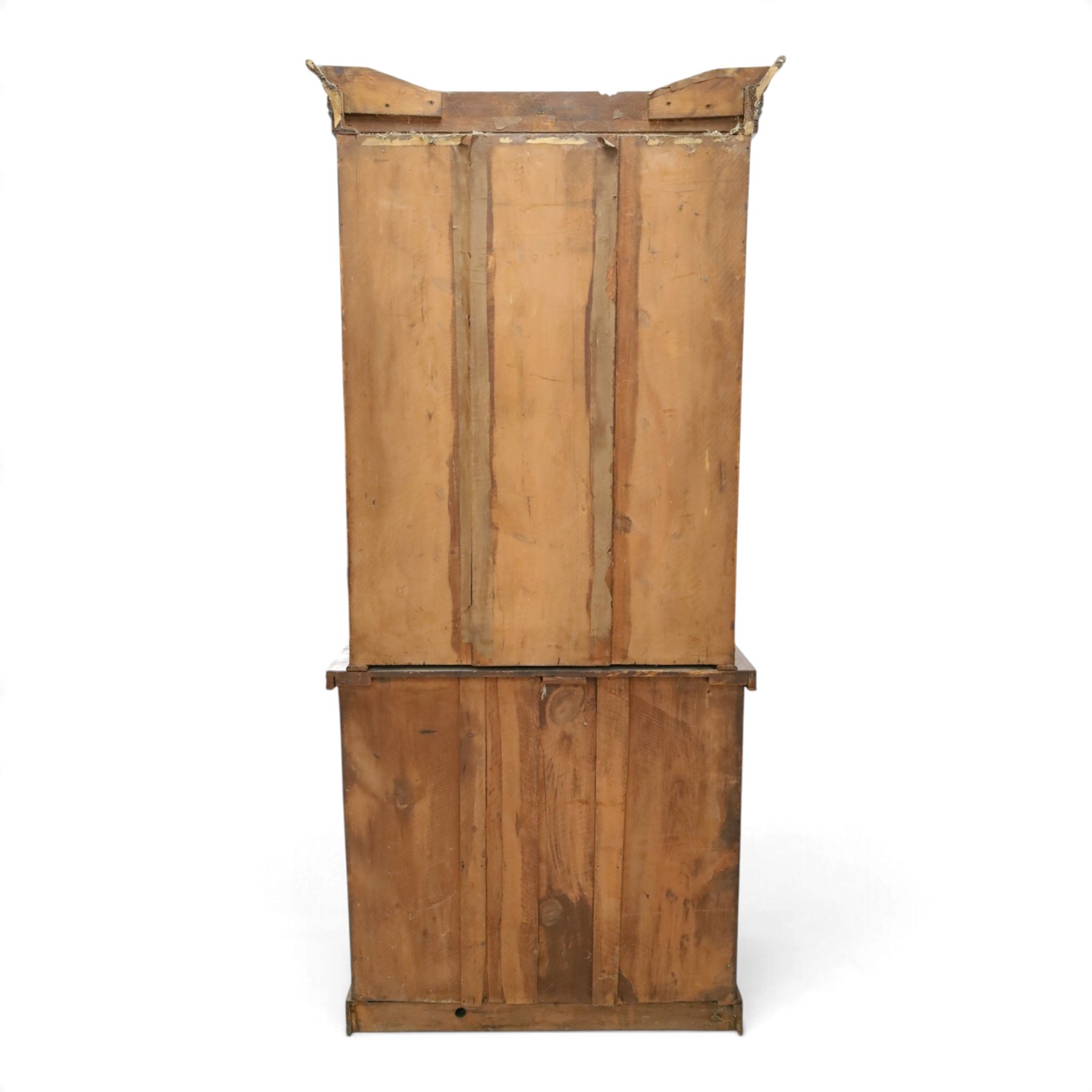 Victorian mahogany bookcase on cupboard of slender proportions, projecting cornice over dentil-frieze, fitted with twin-glazed doors enclosing three shelves, flanked by acanthus corbels, the base fitted with single frieze drawer over panelled cupboard, on skirted base