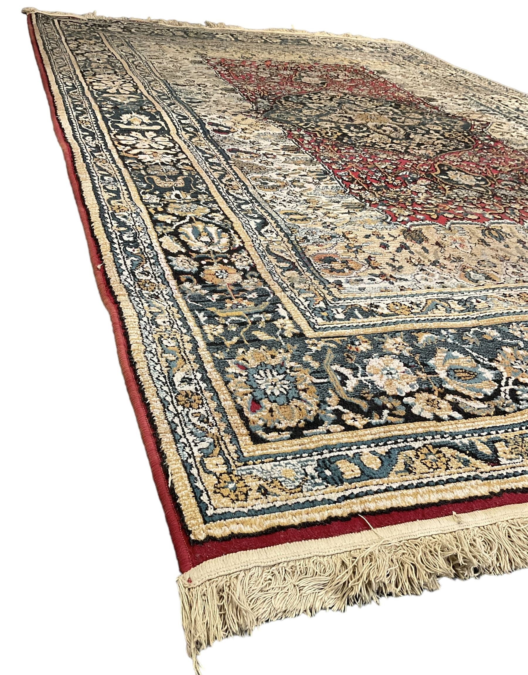 Persian design rug, rectangular crimson ground field with medallion, surrounded by trailing foliate branches, within wide border bands decorated with stylised floral motifs 
