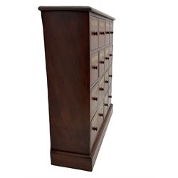Victorian style mahogany chemist apothecary type chest, the moulded top over sixteen labelled drawers, plinth base