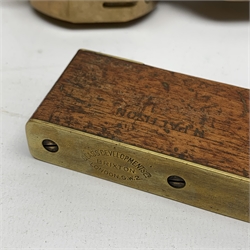 Brass Natural Sine type compass with spirit levels to the dial, bears name of Stanley, D8cm, in earlier mahogany box; brass pocket sextant of drum shaped form, the screw top marked Stanley London; small brass cased compass with pedestal tripod base; and Glass Developments Ltd. hahogany and brass spirit level L31cm (4)