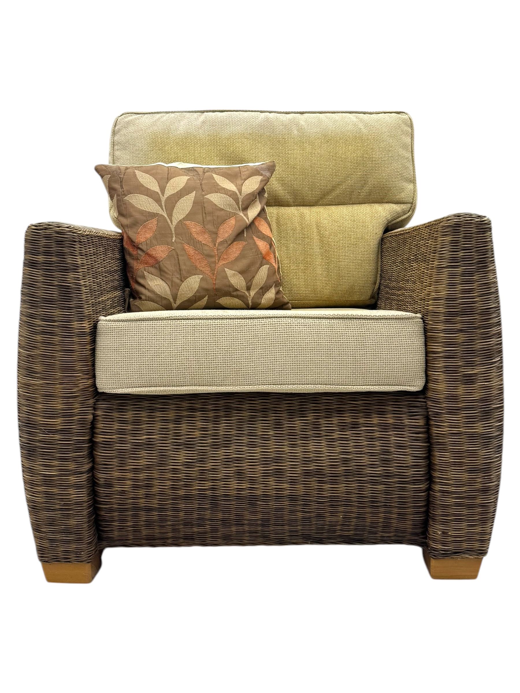 Contemporary two seat rattan conservatory sofa with loose cushions, and pair of matching armchairs, with upholstered seat and back cushions in a beige fabric, curved arms and front complete with scatter cushions 

Chairs (H 92cm, W 75cm, D 84cm)
Sofa (H 92cm, W 130cm, D 84cm)