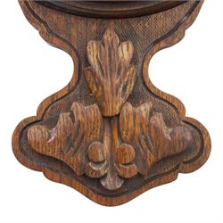 Late Victorian carved oak aneroid barometer, the foliate crest above a glazed thermometer and circular dial, with further carved decoration below, H 75cm