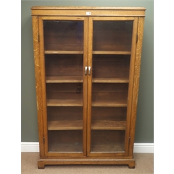  Early 20th century oak bookcase, two bevelled glass doors, four adjustable shelves, bracket supports, W100cm, H159cm, D29cm  