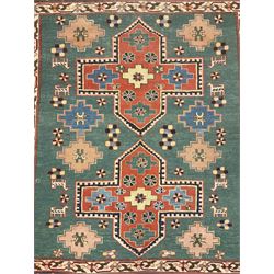 Caucasian turquoise ground rug, two medallions on a field decorated with stylised animal and geometric motifs, the guarded border decorated with further geometric motifs