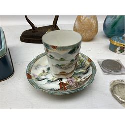 Assorted items, to include two small Art Glass vases, one example with Caithness label, and an Art Glass paperweight, a small cranberry glass jug, Royal Worcester Royal Commemorative trinket box, Noritake cup and saucer, Victorian flat iron, Queen Victorian crown, and three other commemorative crowns, etc., in one box 