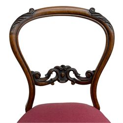 Set of six Victorian rosewood dining chairs, the balloon back carved with foliage scrolls, cartouche carved middle rail with extending scrolls, the seats upholstered in pink fabric, on carved cabriole supports with scrolled terminals 