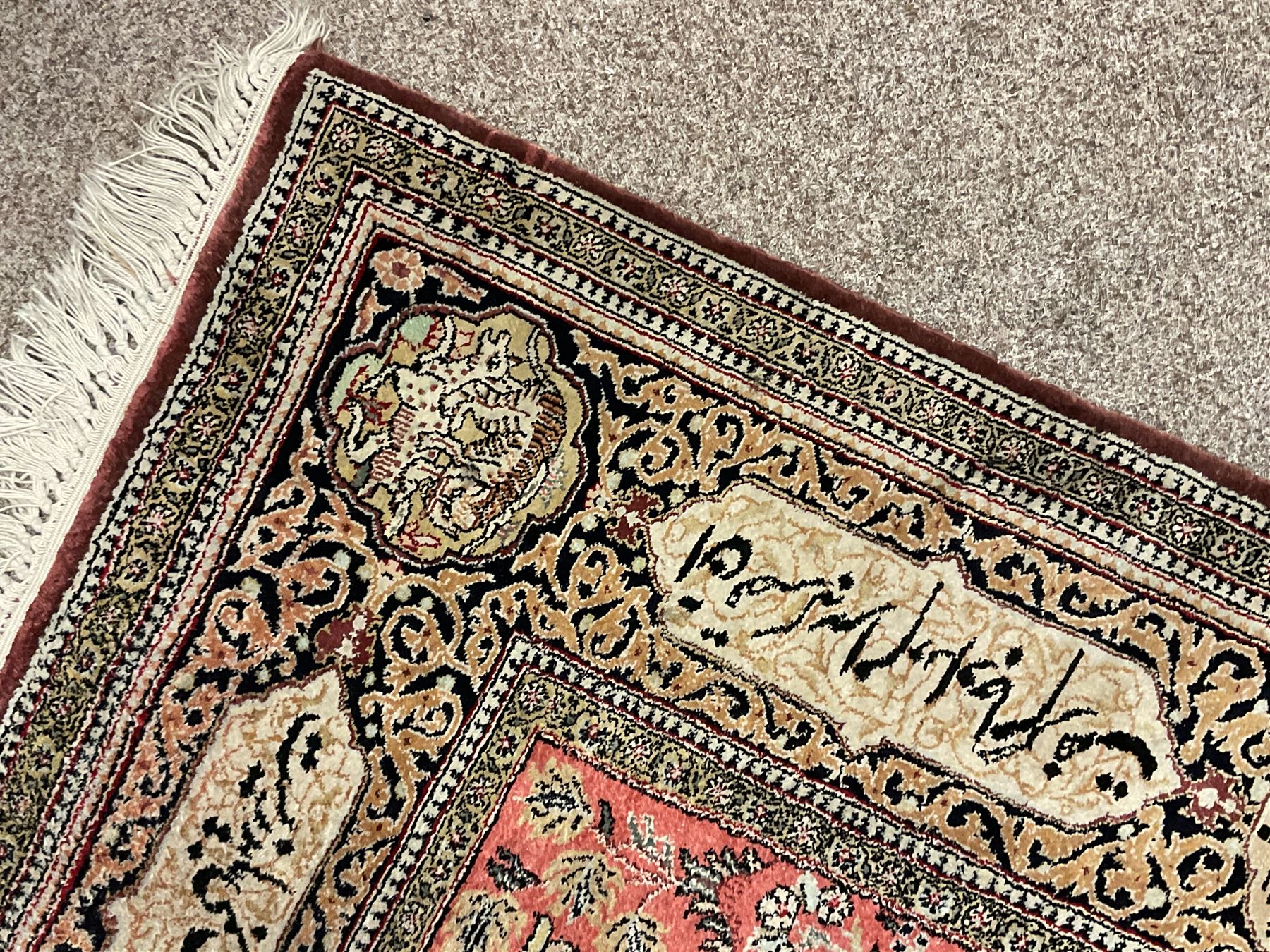 Fine Persian silk and cotton hunting rug, pink ground field depicting hunting scenes, trees and flowers, the border decorated with scrolls and script panel