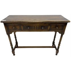 Medium oak side table, rectangular top over three drawers, on turned supports united by H-shaped stretcher rails 