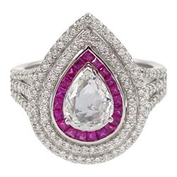 18ct white gold diamond and ruby pear shaped cluster ring, central rose cut pear shaped diamond of approx 0.50 carat, with calibre cut ruby surround and two rows of round brilliant cut diamonds, with diamond set shoulders, stamped 750, total diamond weight approx 1.05 carat 