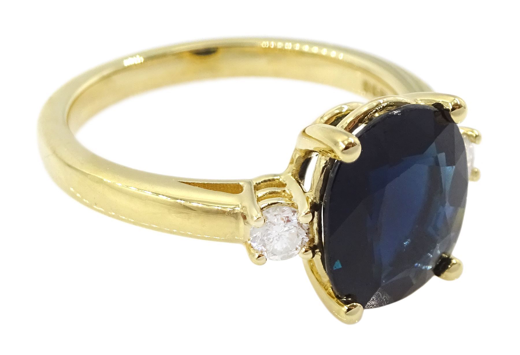 18ct gold sapphire and diamond three stone ring, single oval cut sapphire of approx 3.45 carat, with a round brilliant cut diamond set either side, hallmarked