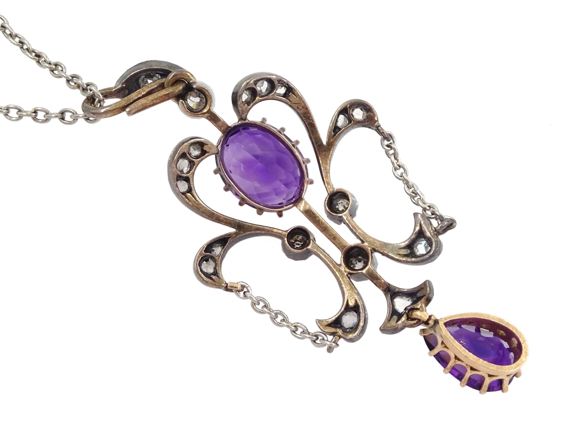 Edwardian silver, gold and platinum amethyst and diamond pendant, oval cut amethyst with old cut and rose cut diamond surround, suspending a pear cut amethyst, on platinum trace link chain necklace