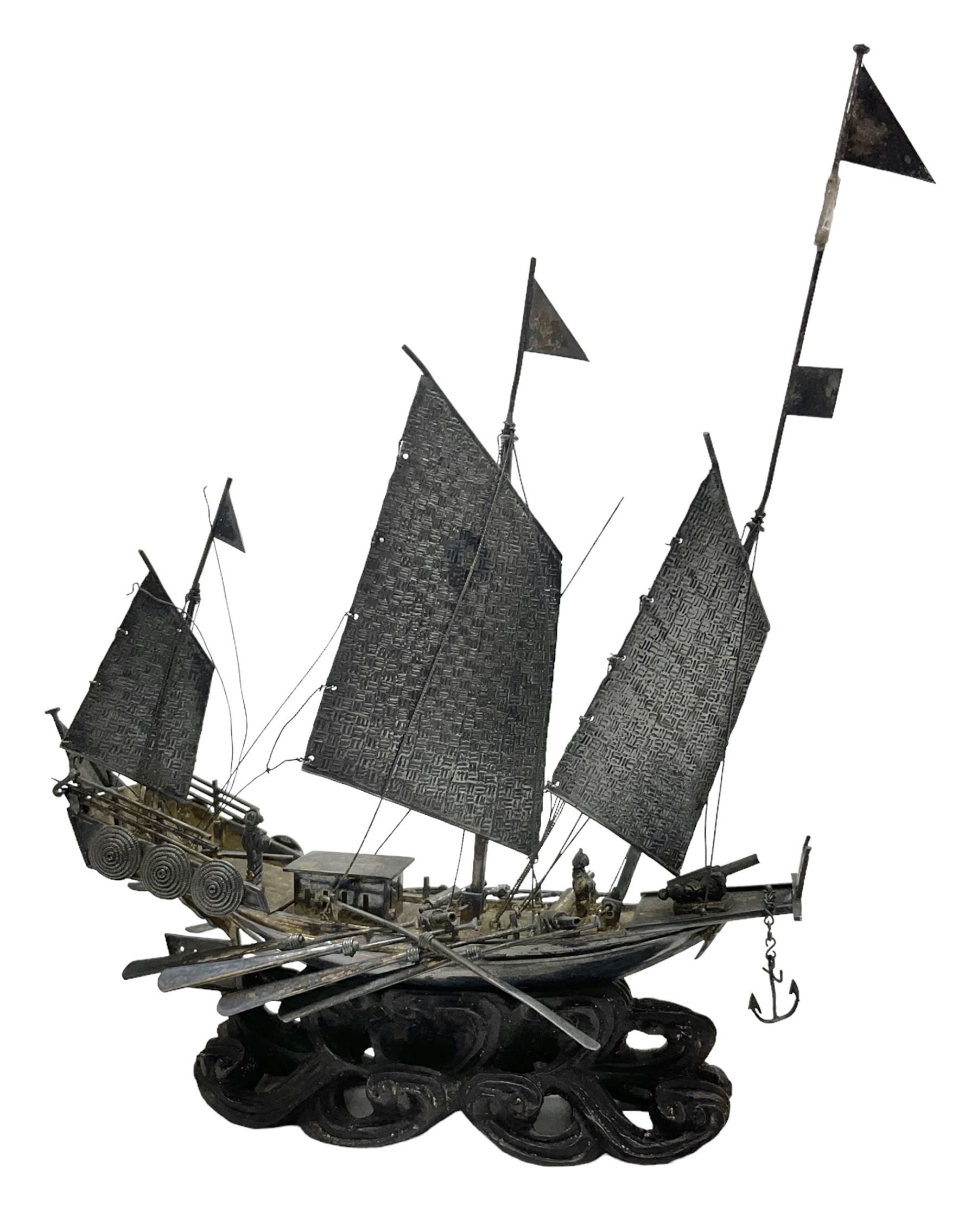 Chinese miniature silver model of a junk ship, with textured sails, mounted upon a carved wooden stand, H14cm