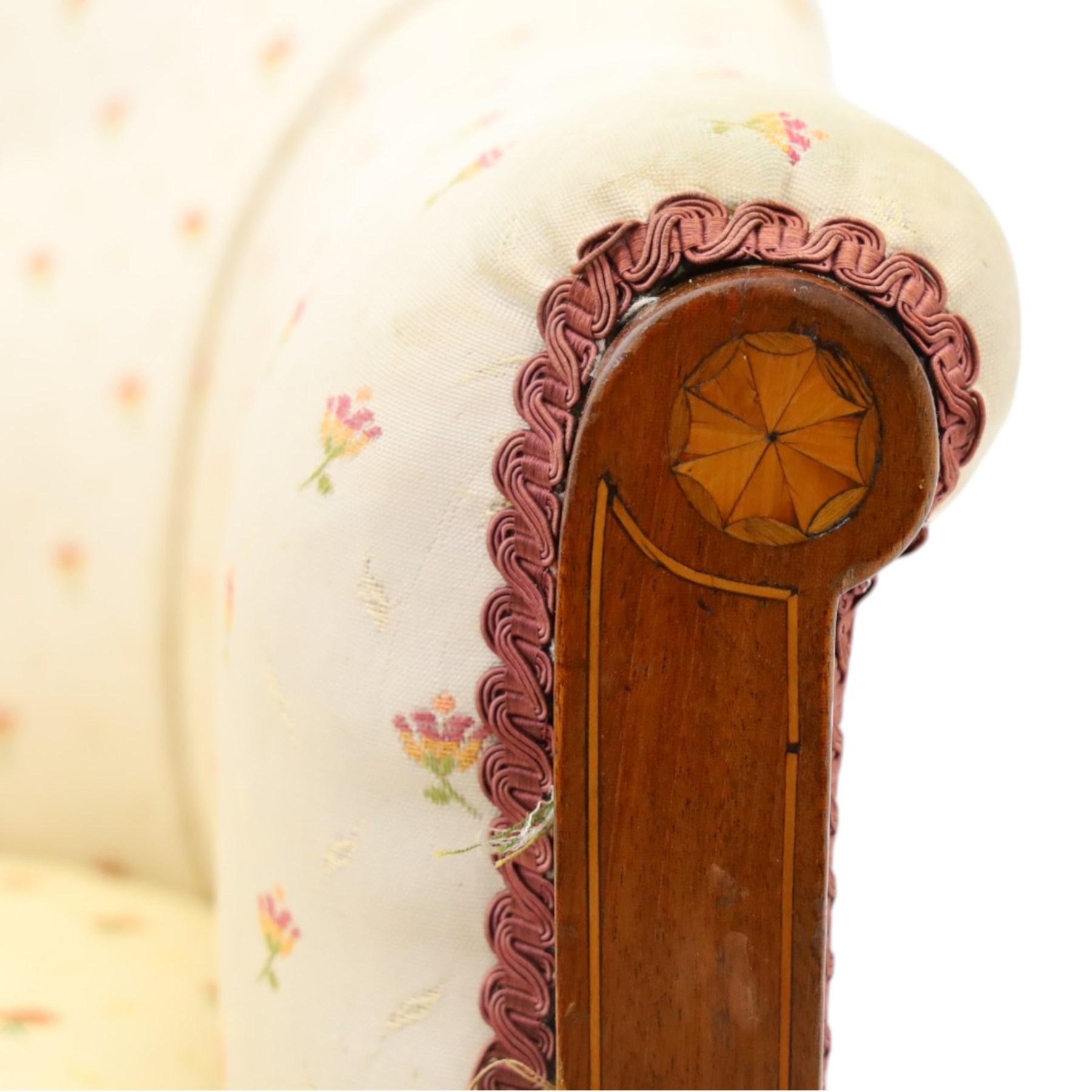 Edwardian inlaid mahogany armchair of modest proportions, spoonback and loose seat cushion on sprung seat upholstered in ivory ground floral fabric, on square tapering supports with ceramic castors