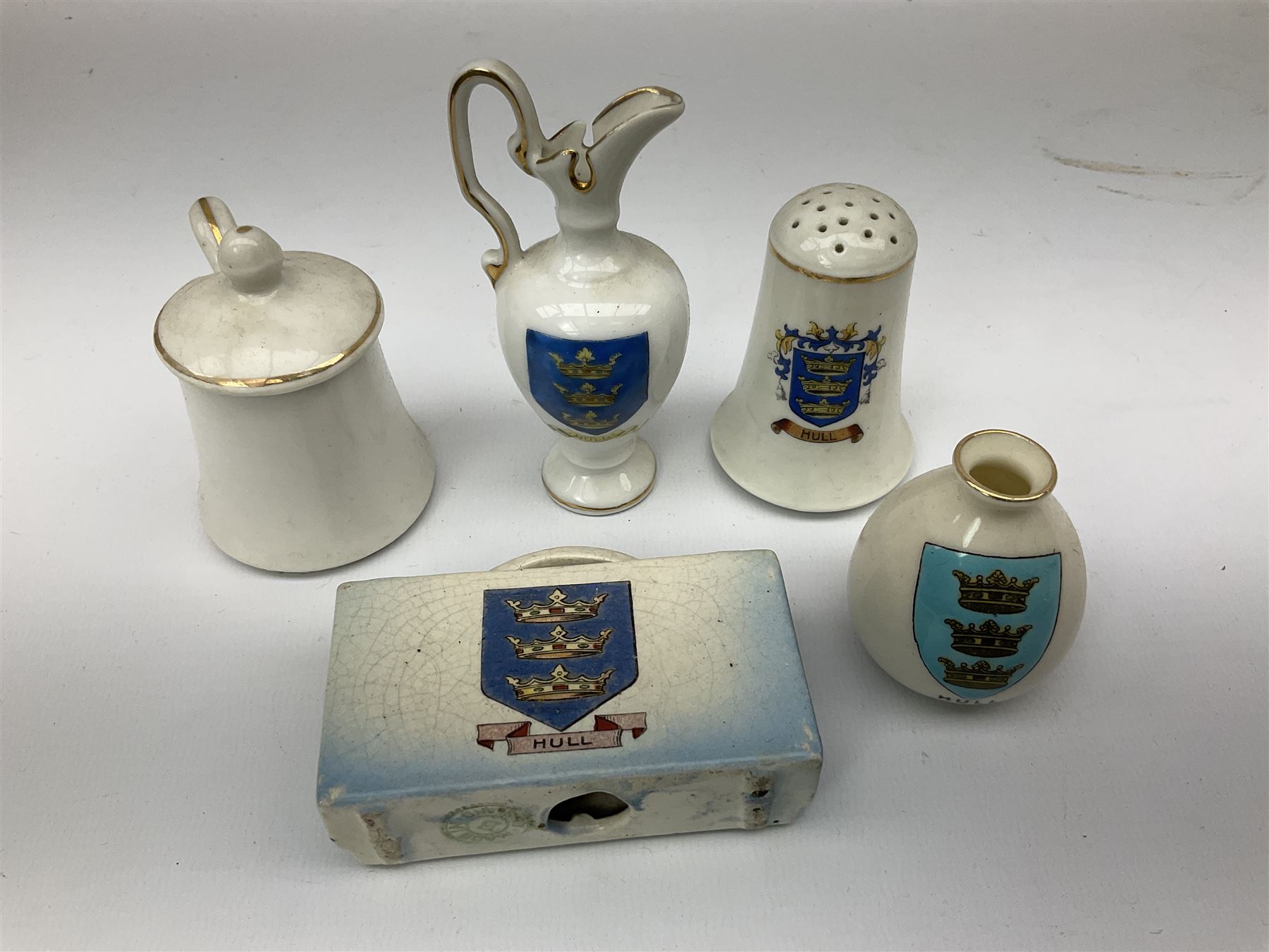 Fourteen items of Hull crested china by W.H. Goss etc including  Boer War, De La Pole and Wilberforce monuments, 3-piece cruet on trefoil stand, various vases and jugs etc  