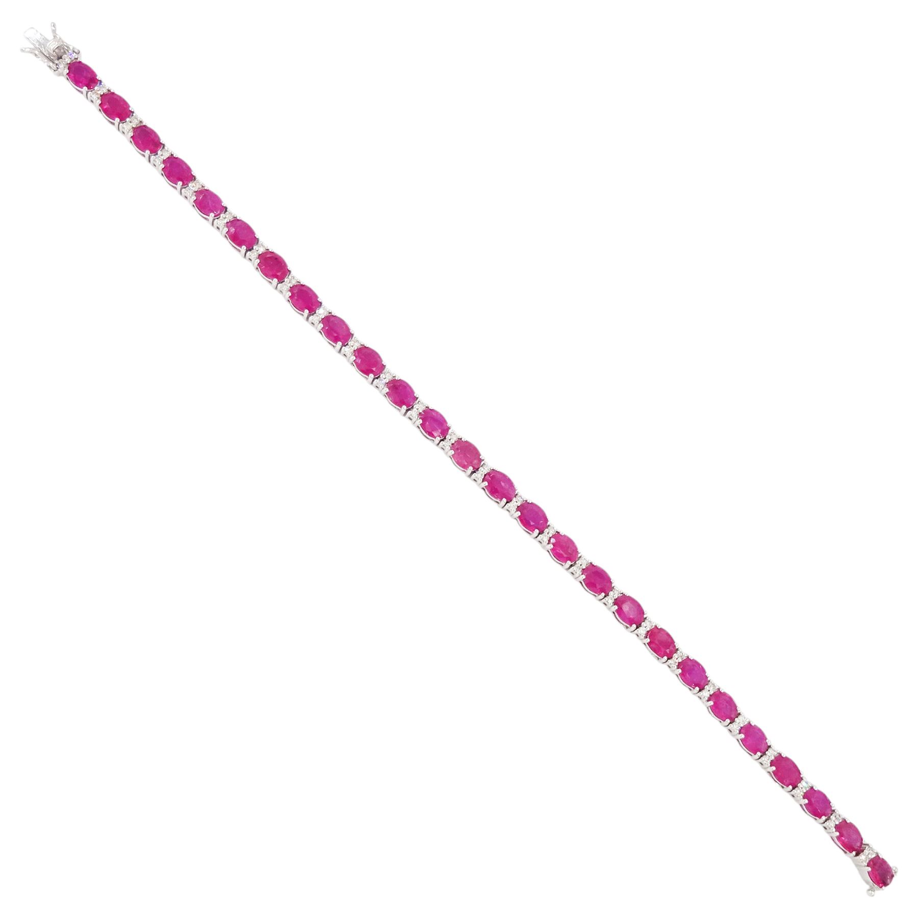 18ct white gold ruby and diamond bracelet, twenty-six oval cut rubies, each spaced by two round brilliant cut diamonds, hallmarked, total ruby weight approx 9.40 carat, total diamond weight 0.50 carat