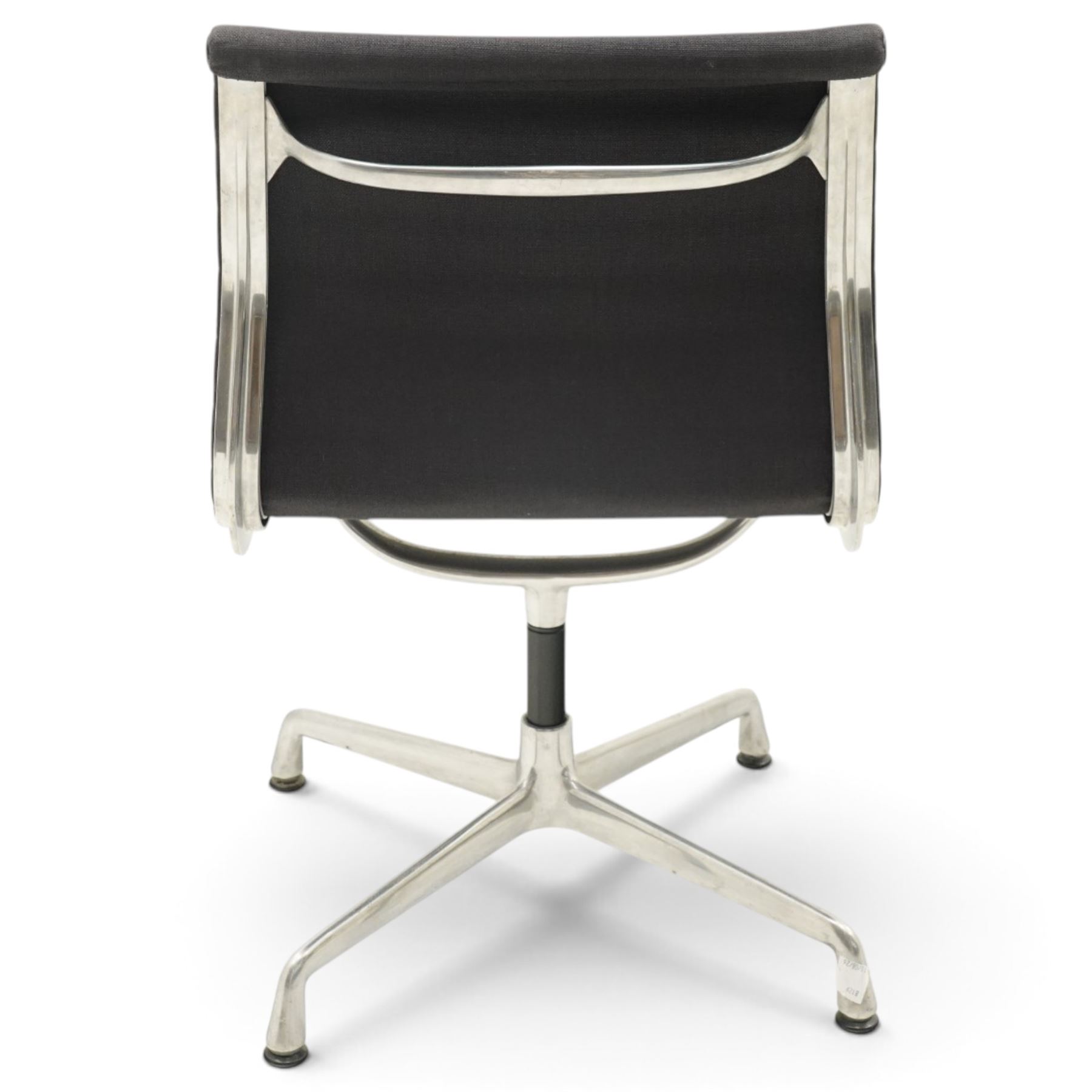 Charles and Ray Eames for Vitra - EA 105 chrome swivel chair upholstered in navy blue, raised on a four point chrome base