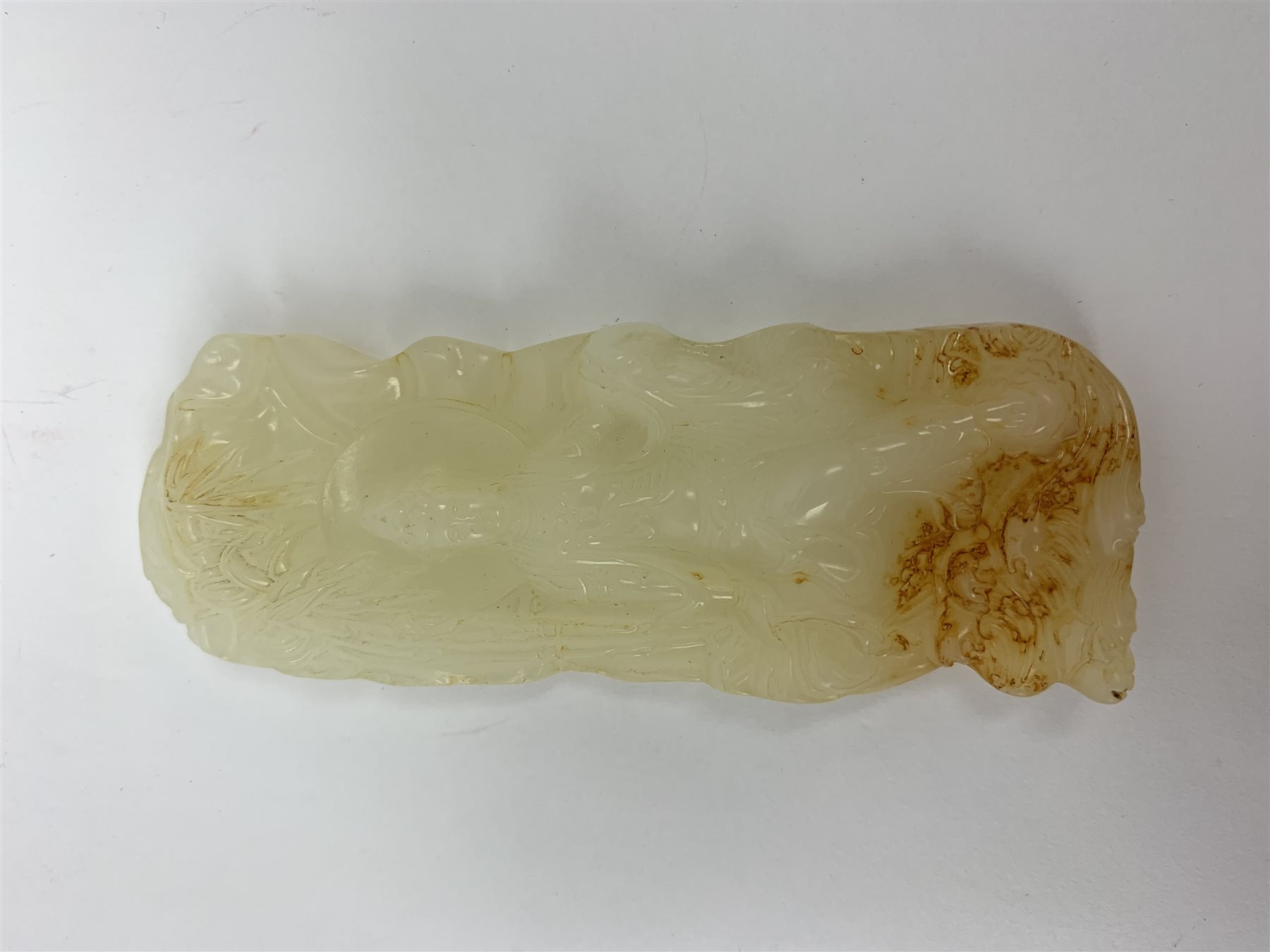 A white Hetian and russet carved jade buddha, H9.5cm.