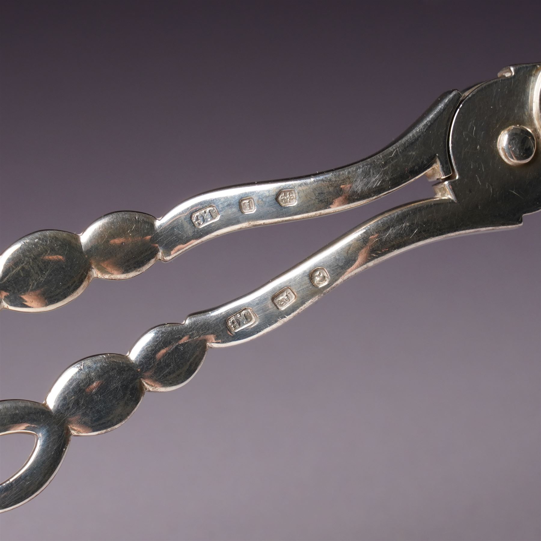 Pair of Victorian silver grape scissors with engraved decoration Birmingham 1860 Maker probably John Gilbert and a small silver sauce boat with crimped rim and C scroll handle Birmingham 1905 Maker Thomas Hayes (2)  