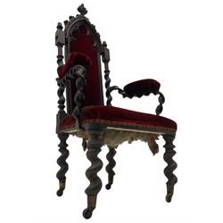 Victorian oak and wrought metal Gothic open armchair, the pointed arched back carved with foliate, cusped inner arch upholstered in red, spiral turned uprights and supports, with arms made of spiral forged metal