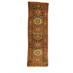 Antique Turkish Heriz red ground runner rug, field decorated with seven central geometric medallions, multi-band border with repeating stylised plant motifs