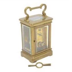 French-Edwardian 8-day timepiece carriage clock with a cylinder platform escapement, anglaise style brass case with four glass panels, dial with a polished gilt mask and foliate decoration, white enamel chapter with Arabic numerals and steel spade hands, . With Key. 