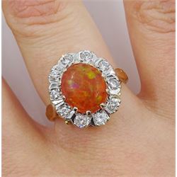 Gold cabochon orange/green fire opal and round brilliant cut diamond cluster ring, stamped 18ct