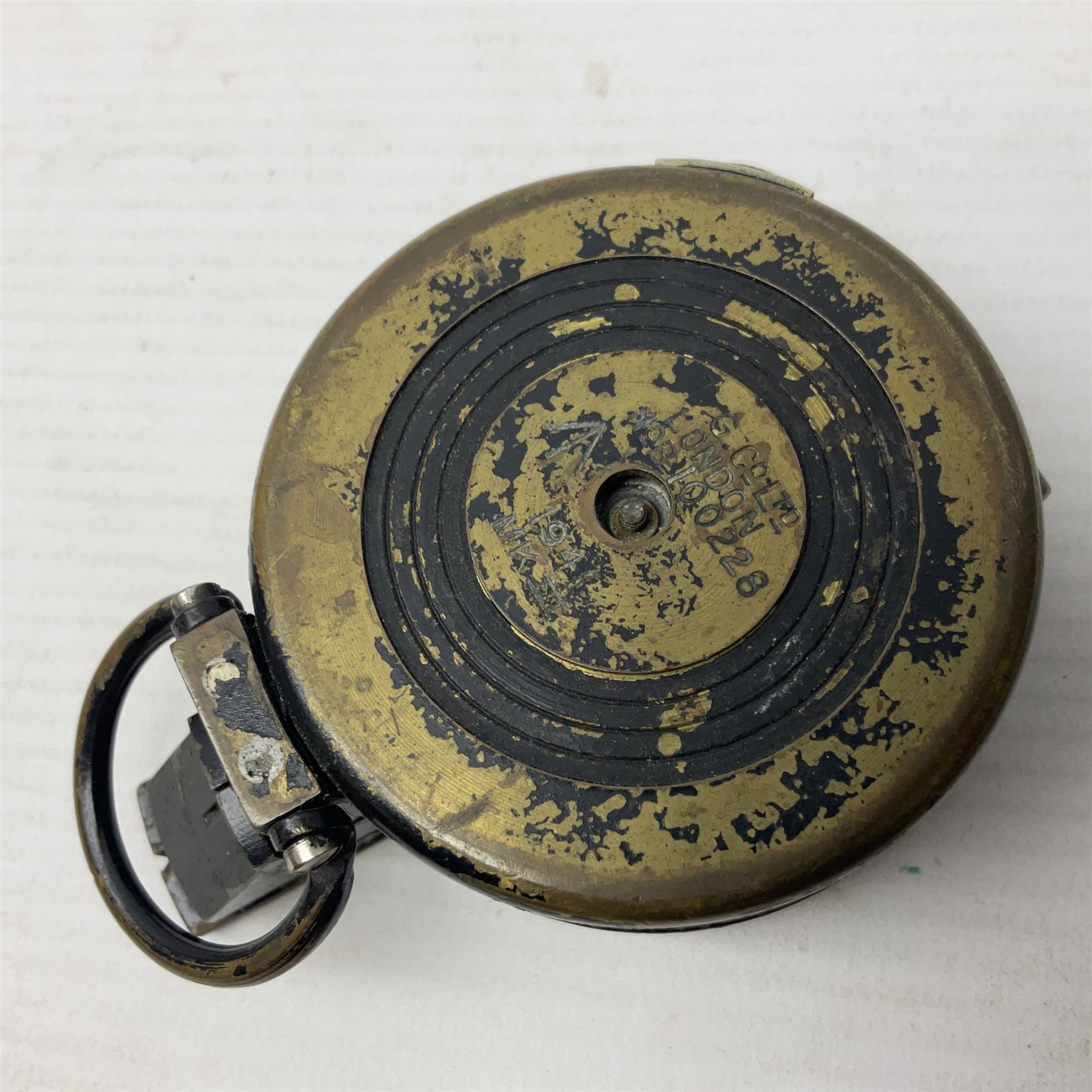 WWII British marching compass, the black lacquered brass case inscribed T.G.Co.Ltd. No.B100228 (broad arrow) 1941 Mk.III; and a ship's brass cased clinometer, the silvered dial marked R(arrow)L, D9cm; in leather carrying case (2)