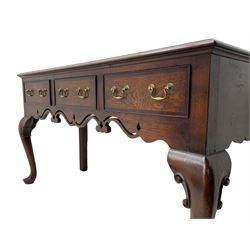 Georgian design oak and mahogany dresser base, the rectangular moulded top with mahogany band, three cocked-beaded and banded drawers over shaped a pierced apron, circular brass handle plates and swan neck handles, on C-scroll carved cabriole supports 