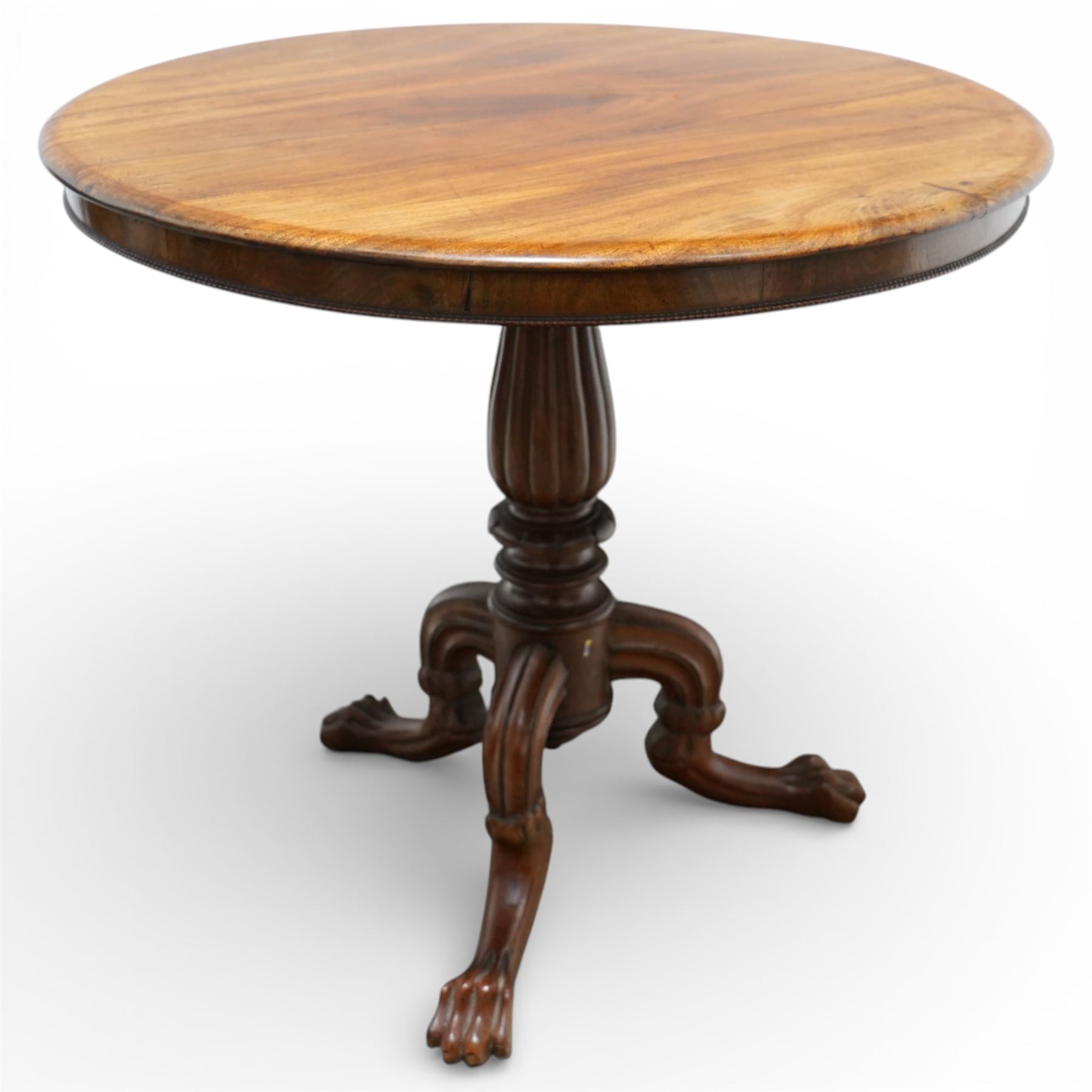 19th century mahogany centre table, with circular tilt top on a turned and reeded column, raised on three carved cabriole legs terminating in paw feet