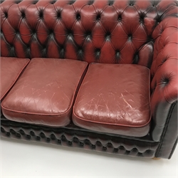 Three seat Chesterfield sofa upholstered in deep buttoned Ox blood leather, turned supports, W185cm