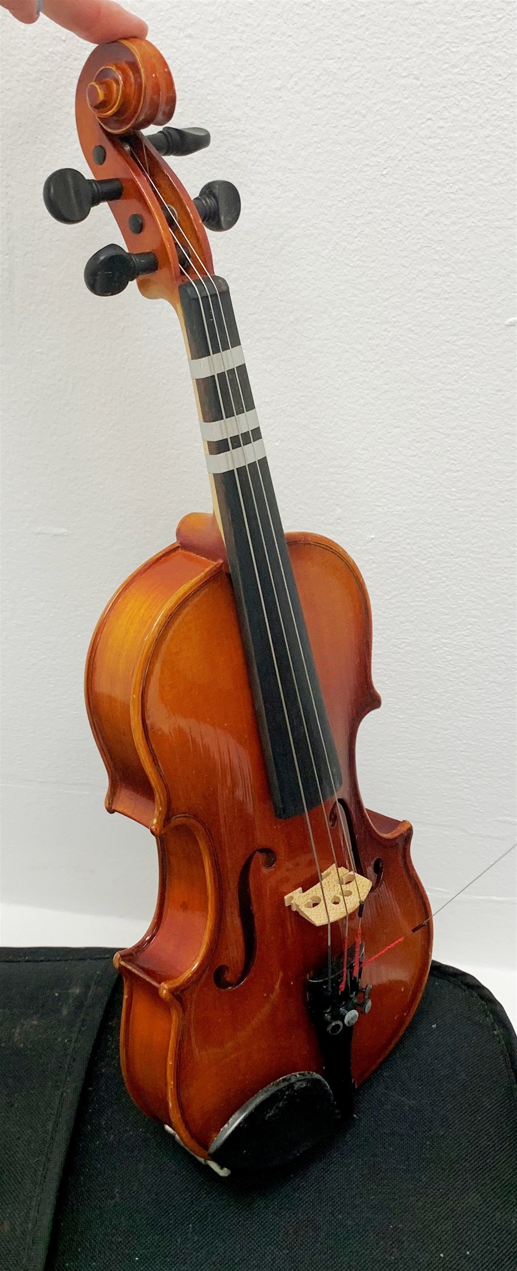 Three modern graduated violins - Suzuki 1/10 size child's violin with 23.5cm single piece back, bears label serial no.94282, 40cm overall; copy of Antonius Sradivarius of Cremona violin dated 1998 with 28cm two-piece back, 47cm overall; and Strobel violin with 35.5cm two-piece back, bears label dated 2006, serial no.512801325, 59cm overall. All cased with bows (3)